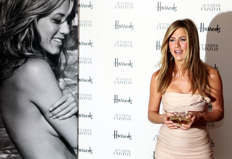 Image: U.S. actress Jennifer Aniston poses with her fragrance 'Jennifer Aniston' during its launch at Harrods in London